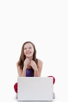 young girl with laptop computer smiling - isolated on white