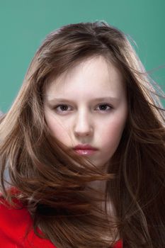 studio shot of an eleven years old girl posing as a fashion model