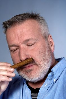 studio portrait of a middle aged man in shirt with a cigar