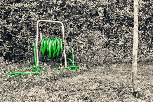 Green water pump in the garden.