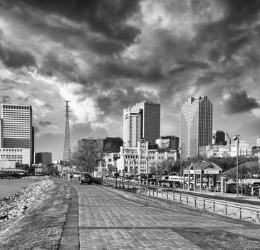 New Orleans skyline with beautiful riverwalk at sunset.