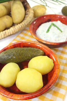 Potatoes and curd with chives on a light background