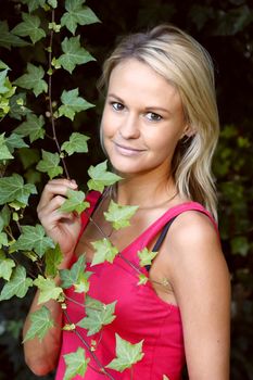 Lovely Young Lady in Garden with green leaves and shoots