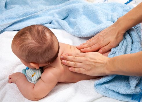 Masseuse massaging 5 months infant