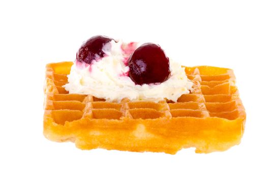 Cherries and whipped cream on freshly baked waffle brightened