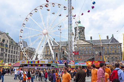 AMSTERDAM - APRIL 26: On the Dam square people in orange celebrating kings day on April 26, 2014 in Amsterdam, The Netherlands