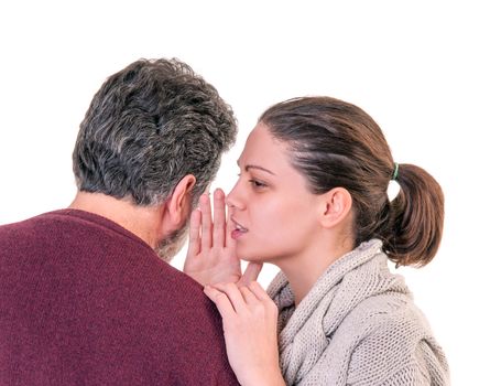 Young woman side portrait speaking in the ear of mature man showing from behind, horizontal shot over white