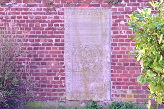 Old grave stone slabs in a wall.