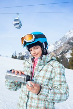 Ski, skier, winter. Lovely girl has a fun on ski - resting and drinking tea.