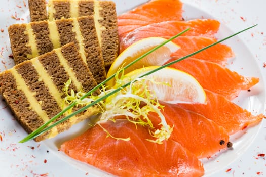 Salmon snack on the white plate, studio shot