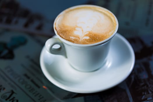 Cup of coffee on a table. Close up