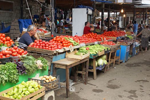 TELAWI, GEORGIA - JULY 5, 2014: People selling vegetables on a typical Georgian market on July 5, 2014 in Telawi, Georgia, Europe