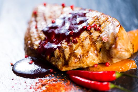 Deer steak with cranberries sauce. Selective focus.