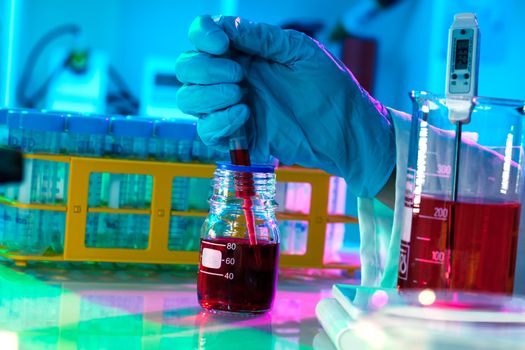 researchers work in modern scientific lab. Preparation of hazardous solution