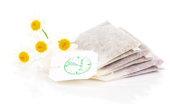 bags of chamomile tea with fresh camomile flower, isolated on white