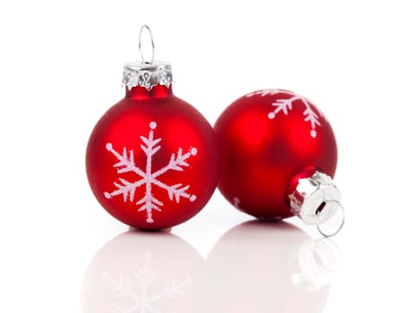 two red christmas decoration balls, isolated on white background