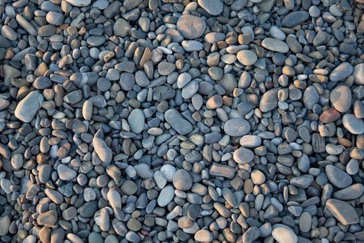 Gray shingle beach texture at the sunset