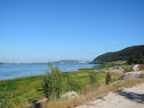 beach on the banks of the Volga with mountain summer day 