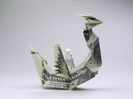 Origami dragon made of hundred dollar bills