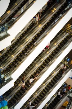 Bangkok, Thailand - September 12, 2013: Crowd on escalator at Terminal21 shopping mall on September 12, 2013. Terminal21 is a new shopping mall in the Asok district in Bangkok, Thailand