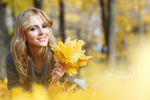 Portrait of beautiful young woman outdoors in autumn park