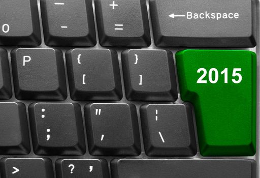 Close-up of computer keyboard with  green twenty fifteen new year key