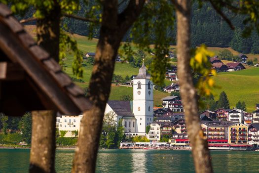 View of St. Wolfgang village waterfront at Wolfgangsee lake with beach toys in front, Austria