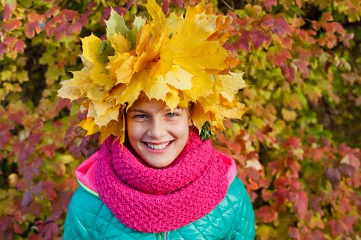 Closeup portrait of Adorable cute girl with autumn leaves in the beauty park