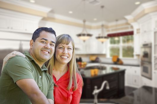 Happy Mixed Race Couple Inside Beautiful Custom Kitchen.