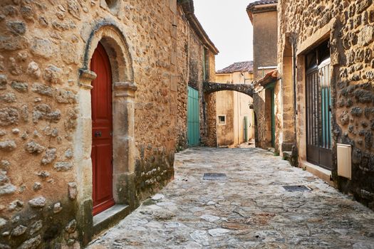 Street with ancient buildings in Grambois village, South France, Provence