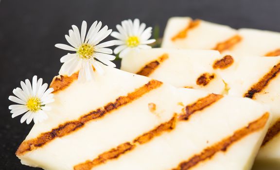 Halloumi cheese frying in grill pan. Closeup