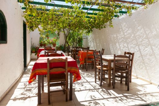Tables with chairs at typical greek cafe