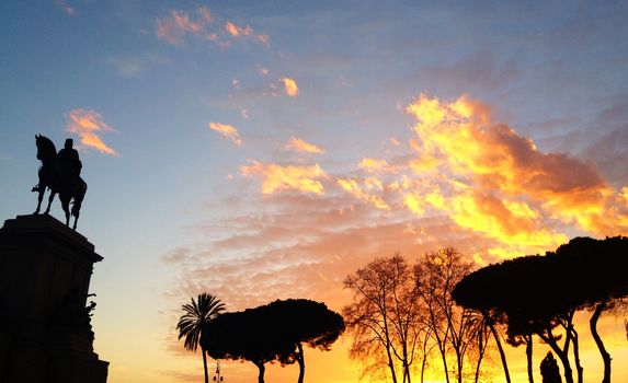 a warm sunset over a monument in Rome