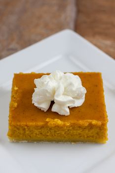 Pumpkin pie bars with fresh whipped topping.