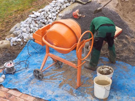 Man at work on concrete mixers