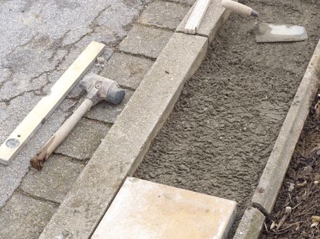 Lay paving stones