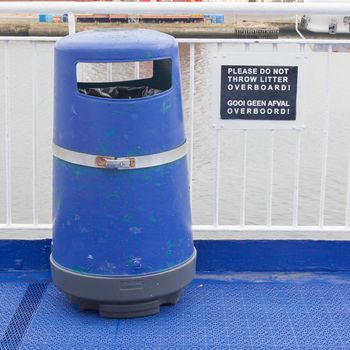 Blue bin on deck of cruise liner, do not throw litter overboard