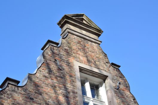 The final upper wall surface of a building is called a pediment. 
This may have caused by the gabled roof shape and design different forms.