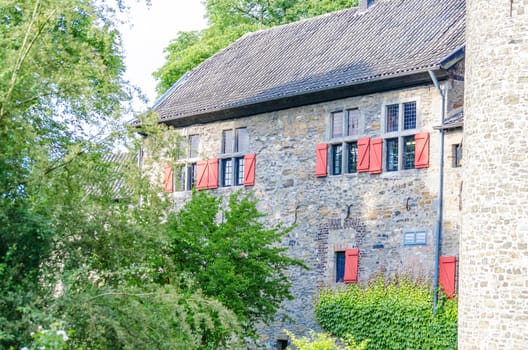 Look at an old castle building with a tower and moat.