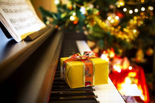 Christmas gift on piano. Chrismtas decoration with gift on piano