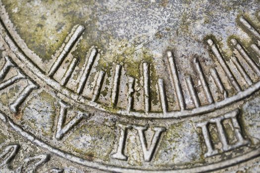 Close up of Roman numerals on weathered  sundial