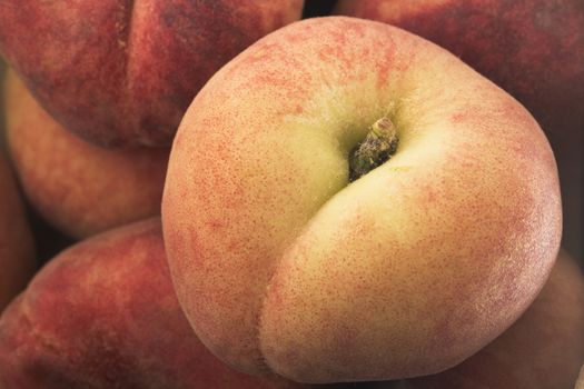 Close Up of flat peach on top of pile.
