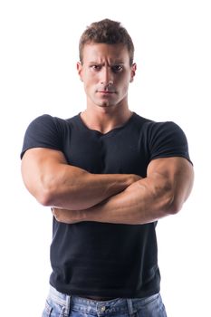 Confident Young Muscled Man in Black Shirt Crossing Arms in Front of the Camera with Serious Face. Isolated on White Background.