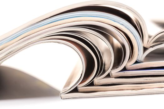 Stack of magazines on white background with reflection