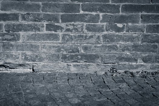 Very old brick wall texture background with stone street