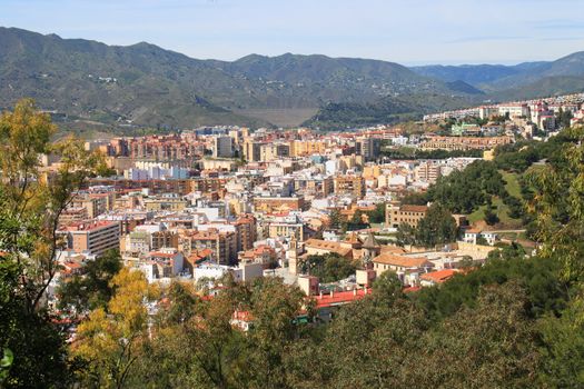 View of Malaga Spain, with mountains in the back and trees in front