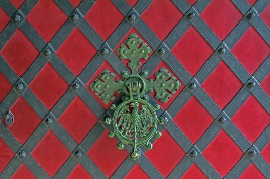 Close up view of an ornamental castle door knocker.