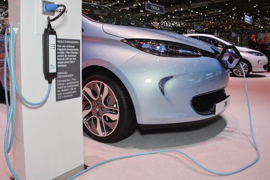 GENEVA, SWITZERLAND - MARCH 4: Renault ZOE EV and charging station on display during the Geneva Motor Show, Geneva, Switzerland, March 4, 2014. 