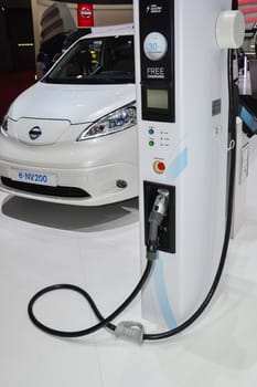 GENEVA, SWITZERLAND - MARCH 4: Nissan e-NV200 and charging station on display during the Geneva Motor Show, Geneva, Switzerland, March 4, 2014.  