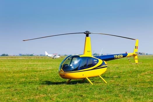 Brasov, Romania - August 12, 2010: Helicopter on a green grass field preparing to take off